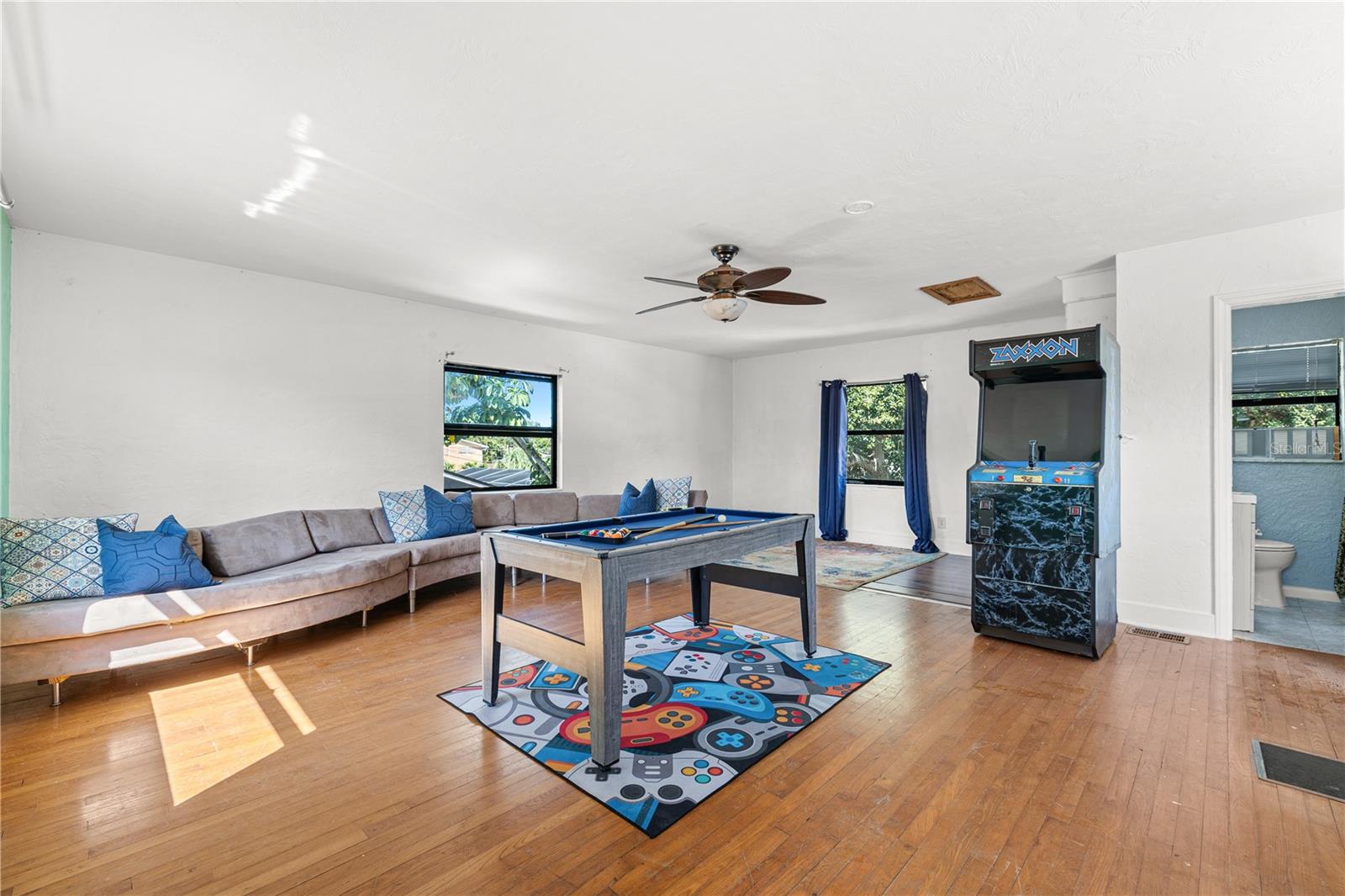 Currently used as a game room, this upstairs apartment features a bathroom and kitchenette.