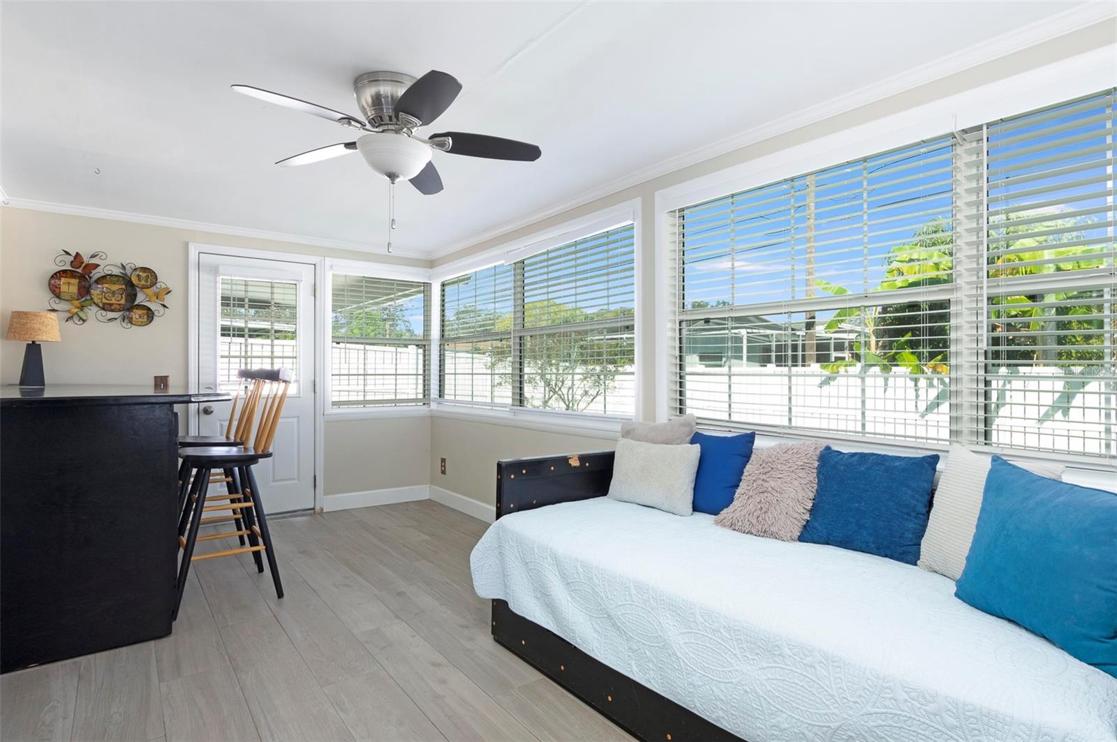 The custom built furniture in this room can stay. The table / cabinet that you see on the left is ideal for puzzle making, crafts, extra storage and more.