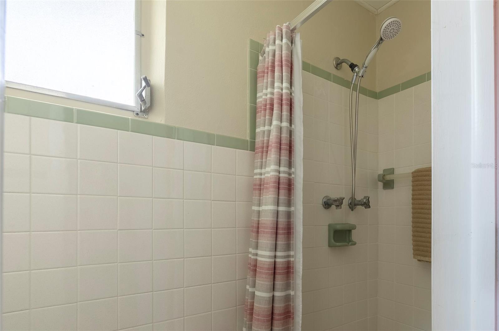 The garage 1/2 bath has a shower and commode. There is a laundry sink in the garage.