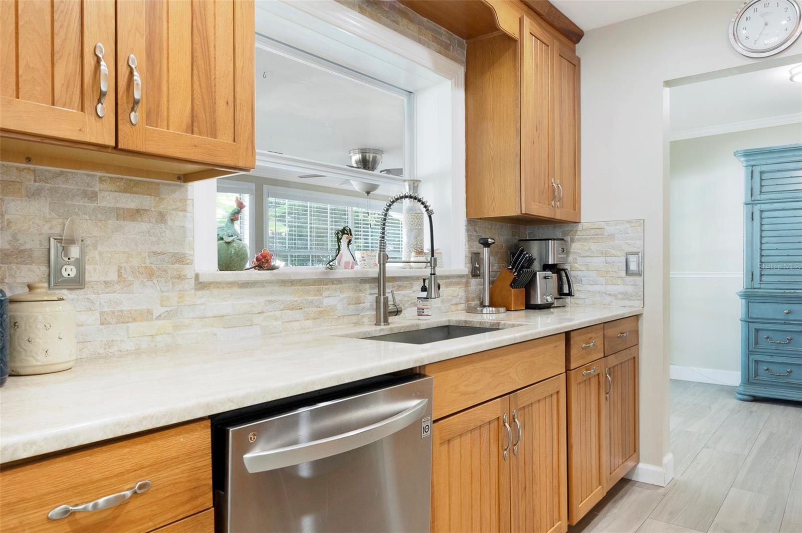 The gorgeous Quartzite countertops and brick backsplash look better in person.