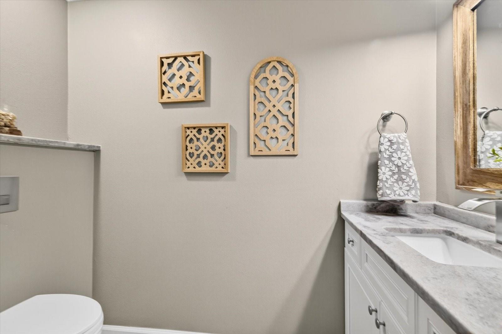 1/2 bath located between the kitchen and dining area