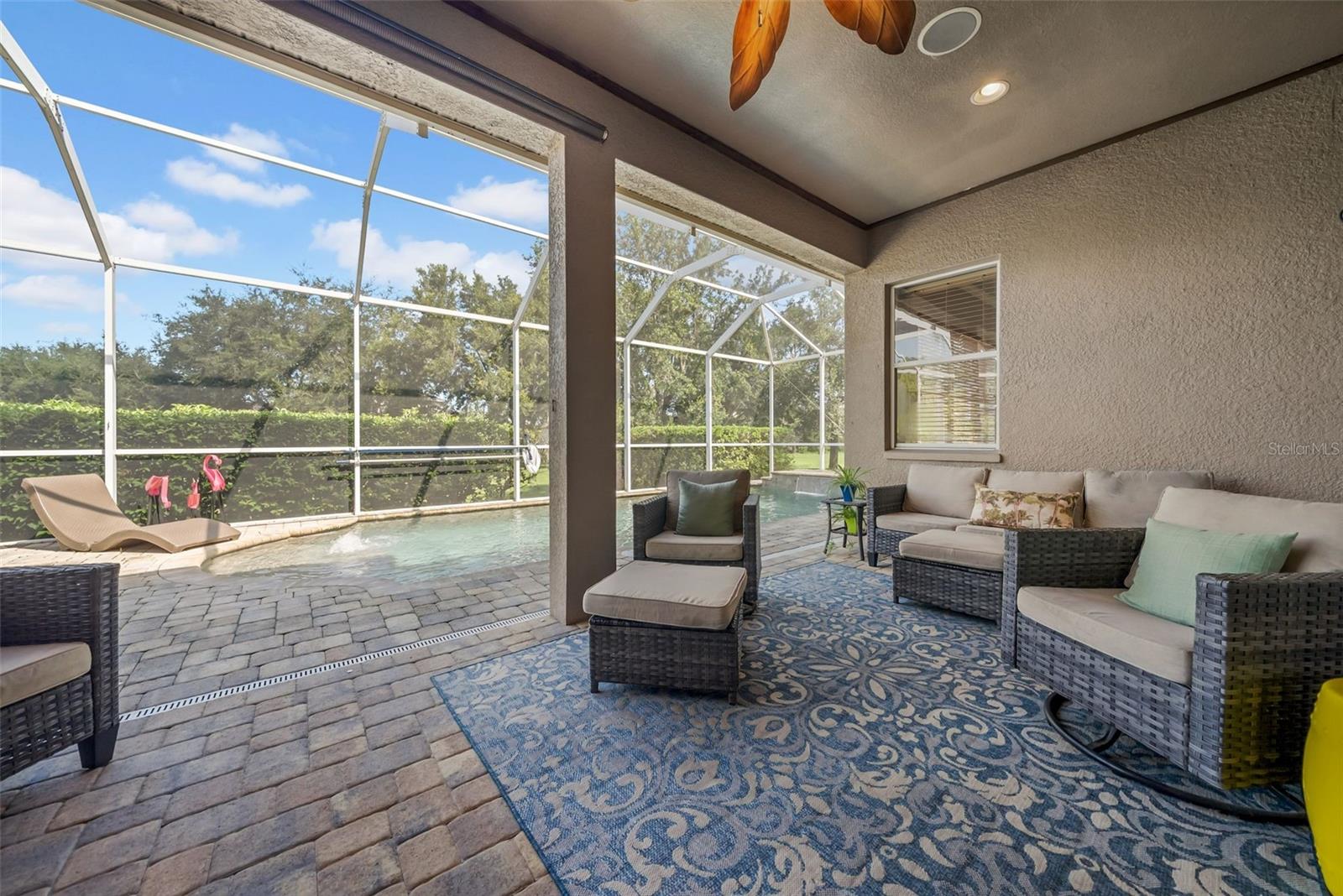 Covered outdoor lounge area with bluetooth speakers.