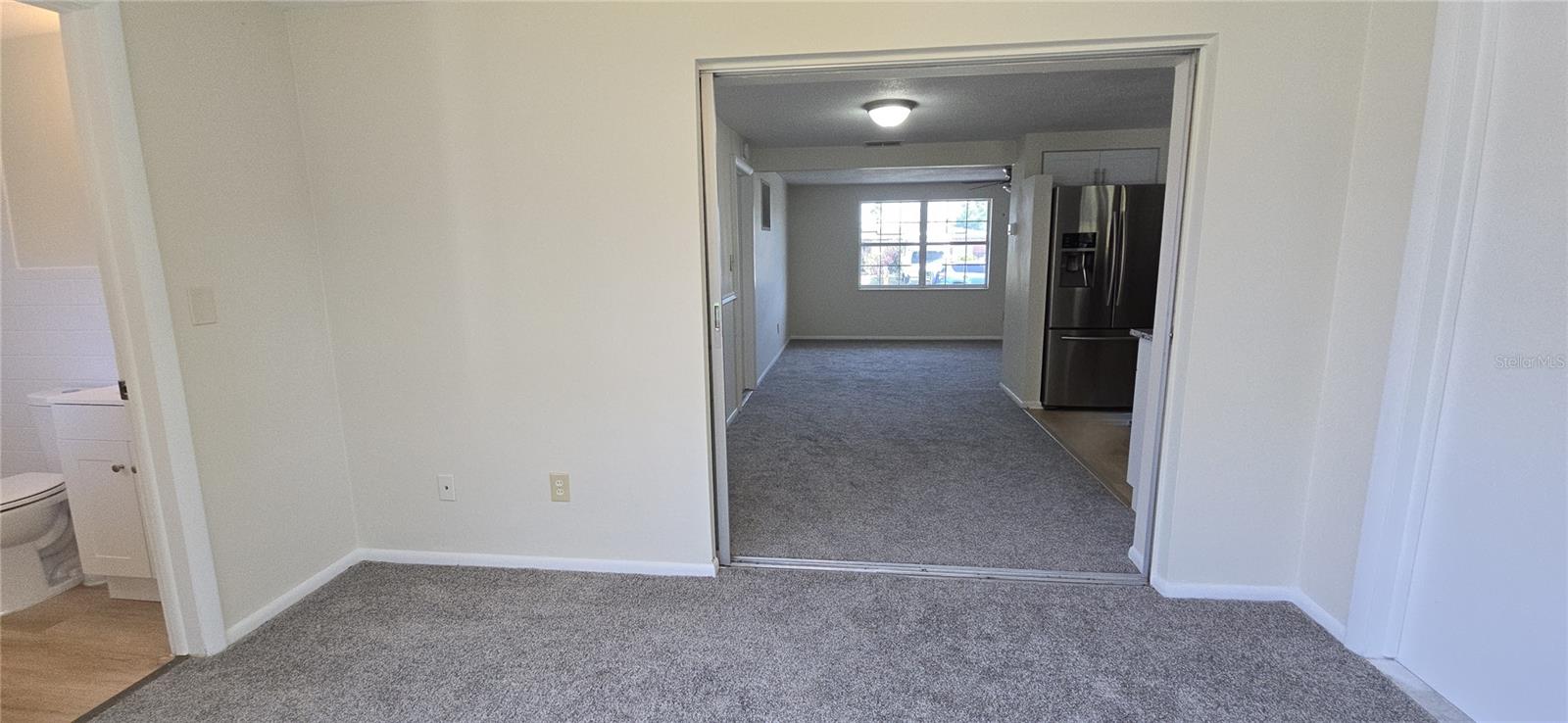 VIEW FROM BONUS ROOM TOWARDS LIVING ROOM