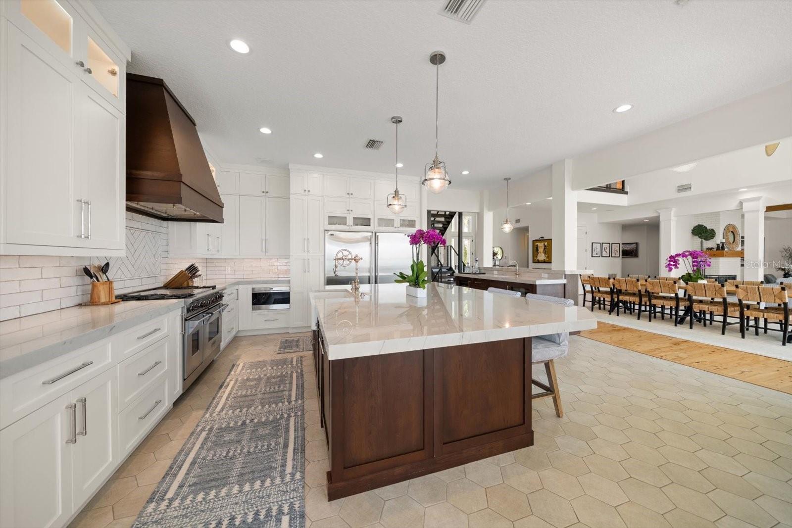 Gourmet kitchen with Wolf 4 burner gas stove/grill/griddle & double ovens and Subzero refrigerator and freezer