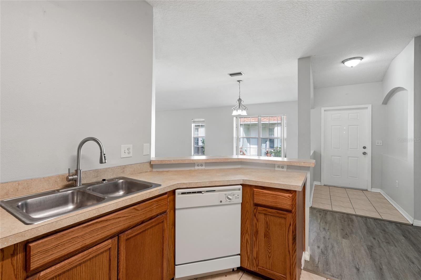 View from the kitchen over the breakfast bar into the dining room and living room.