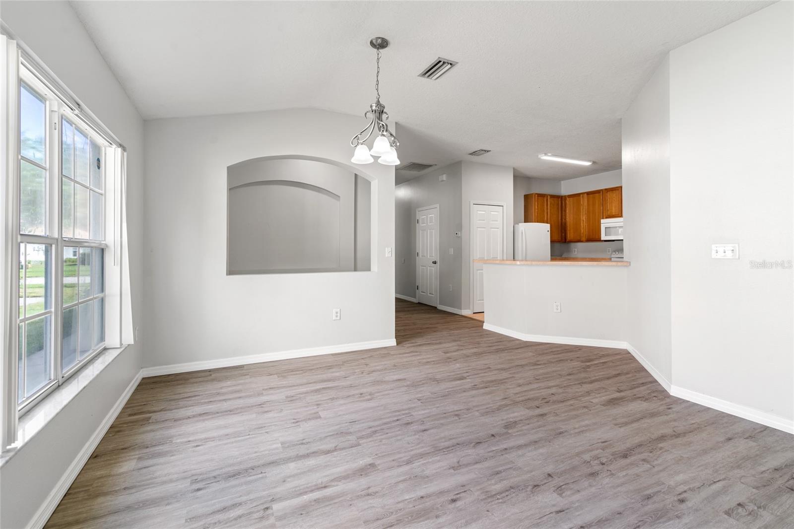 View from the living room into the dining room and kitchen.