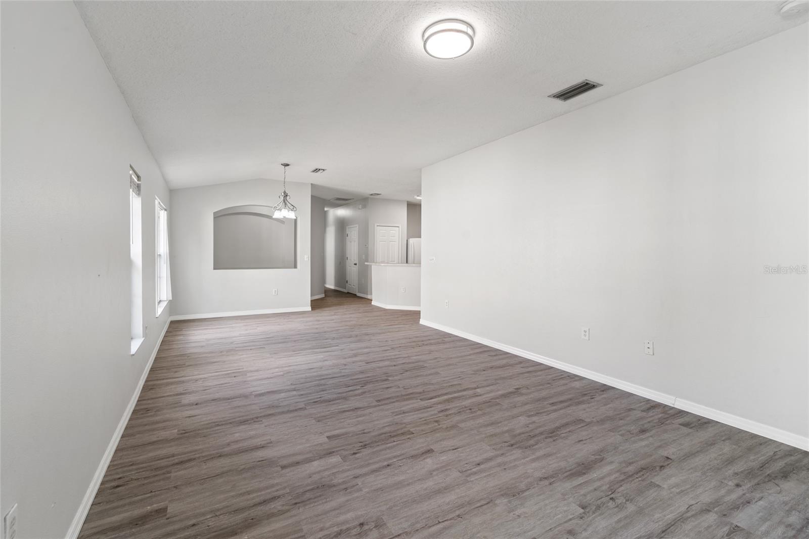 View from the living room into the dining room and kitchen.