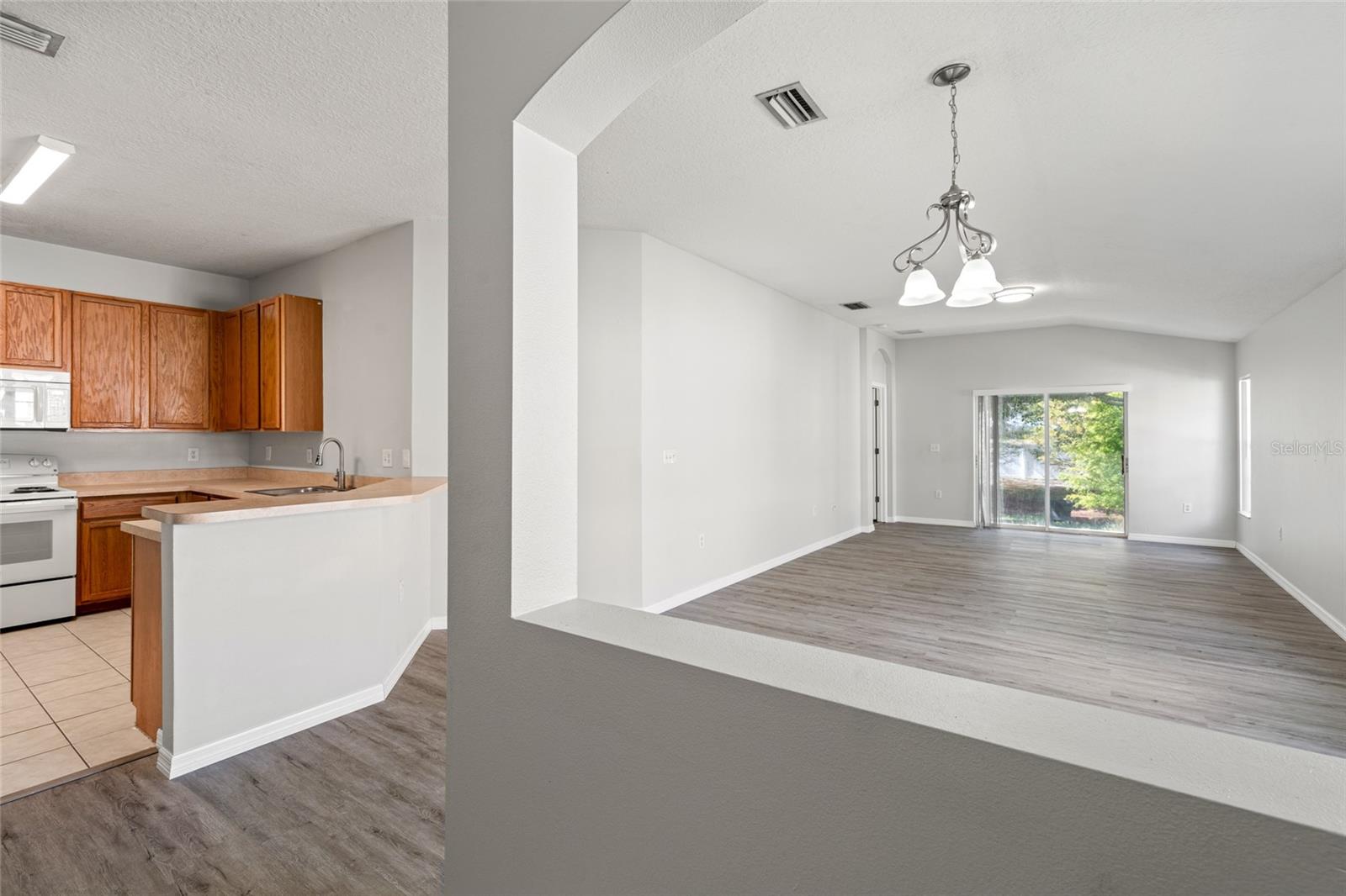 View from the foyer into the kitchen, dining room, and living room.