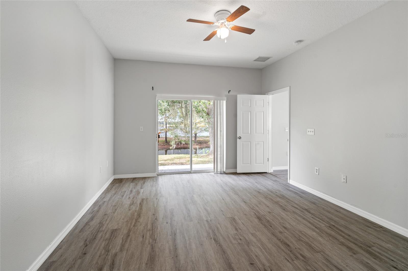 Primary Bedroom with a view, and entry to the backyard.