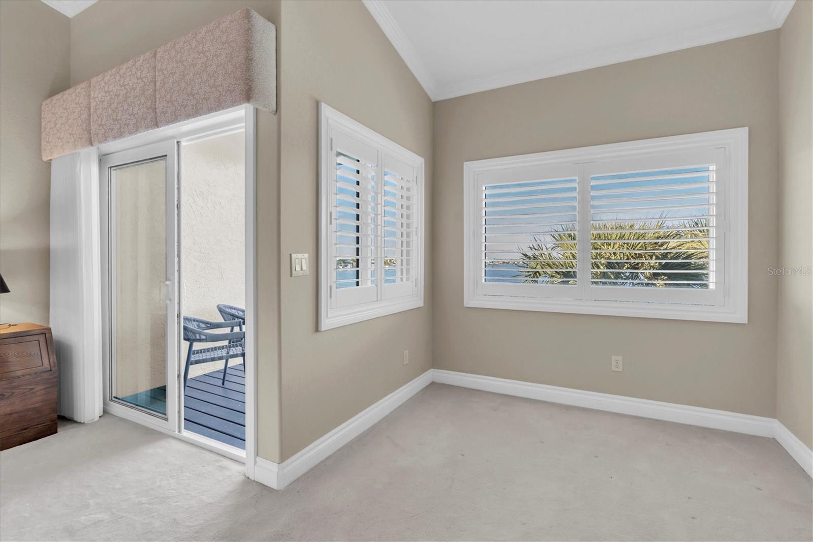 Primary bedroom with balcony & water view