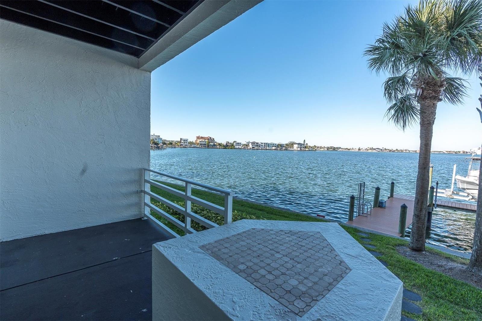 Ground level patio with path to water