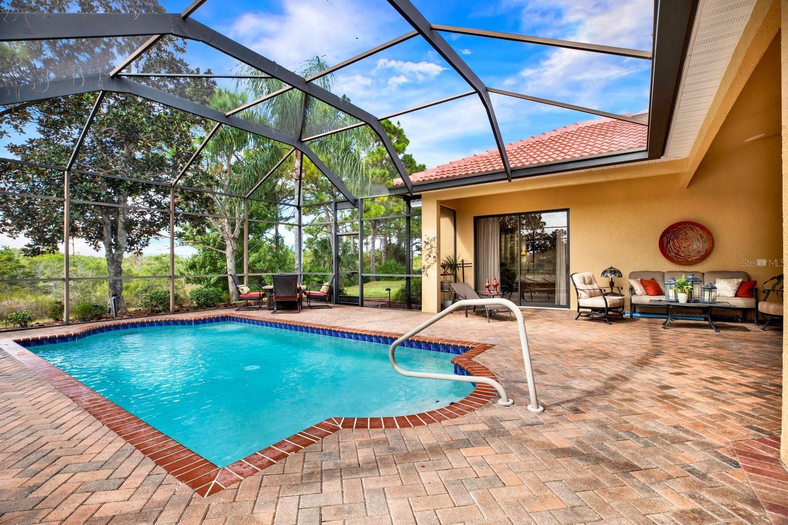 Luxury poolside oasis overlooking serene pond  and peaceful conservation views.