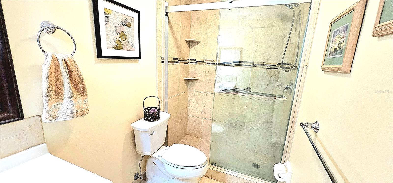 Shower has soft slide heavy glass doors.