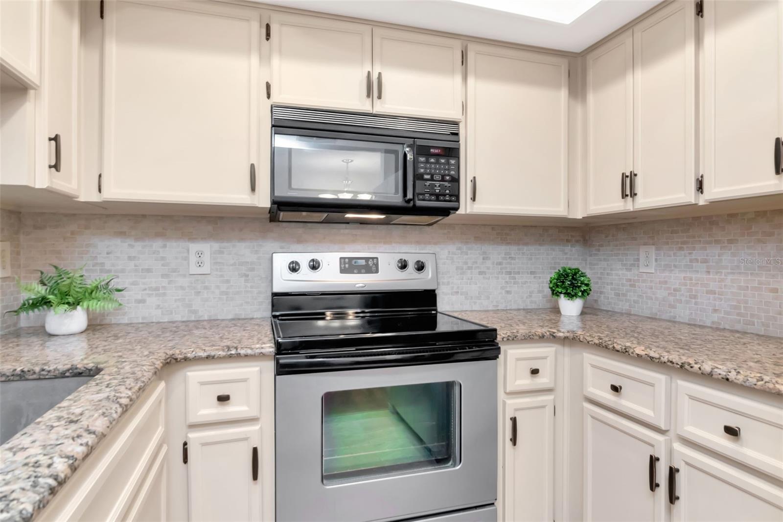 Professionally painted cabinets with granite counters & coordinating tile splash walls~