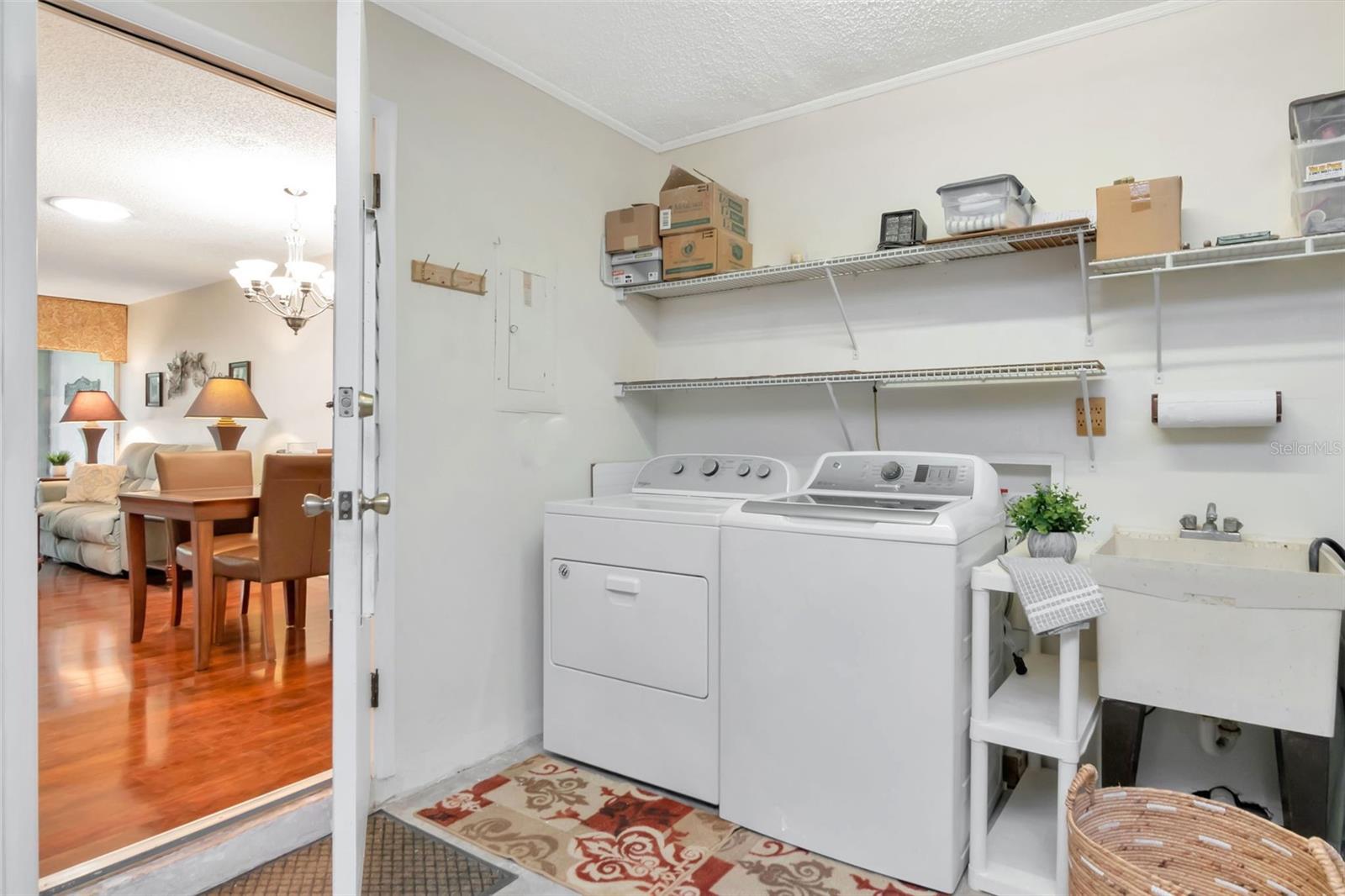 Efficient laundry station with utility sink & newer washer conveniently located~