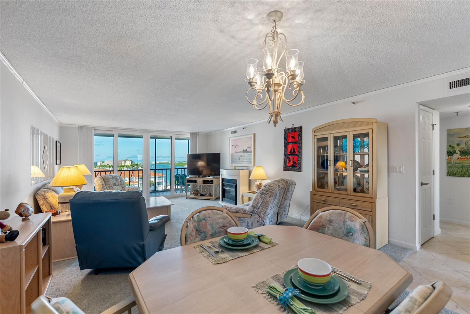 ... Living Area Looking Out Towards Intracoastal Water Views... Hall way to Master & Guest Bedrooms on Right.. New Table Setting.