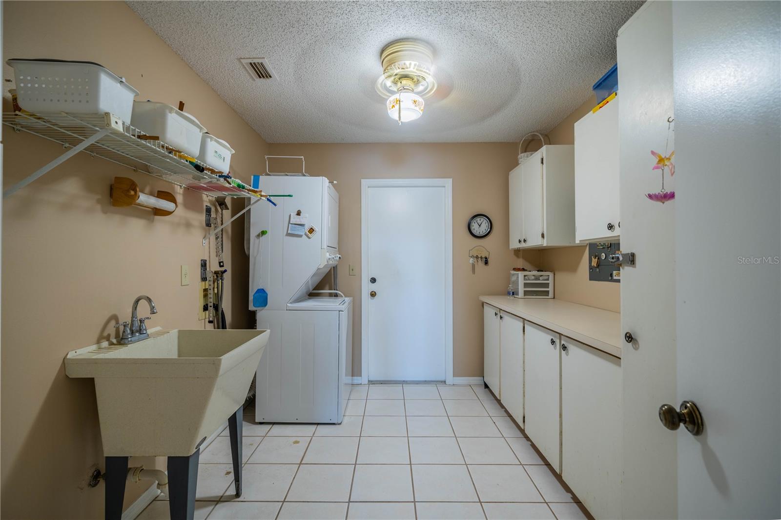 Large laundry room with utility sink