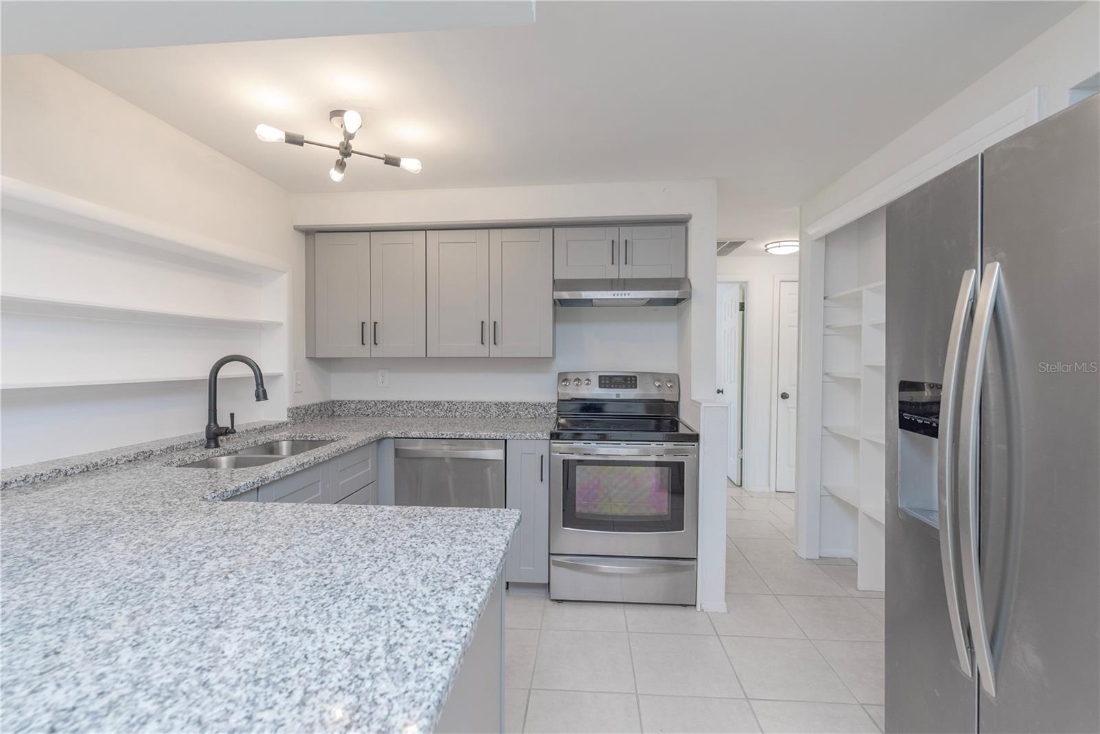 Kitchen with granite counters and stainless steel appliances.