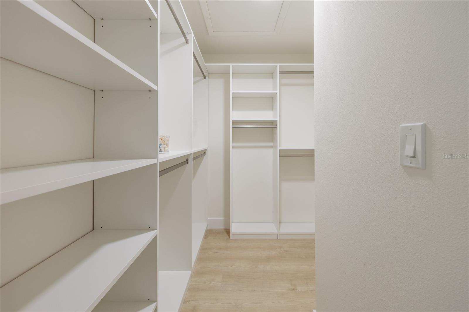 Massive walk-in closet provides essential storage for your full wardrobe needs