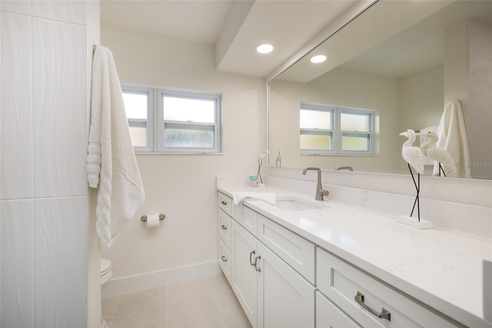 Crisp clean guest bathroom with modern fixtures and ample storage