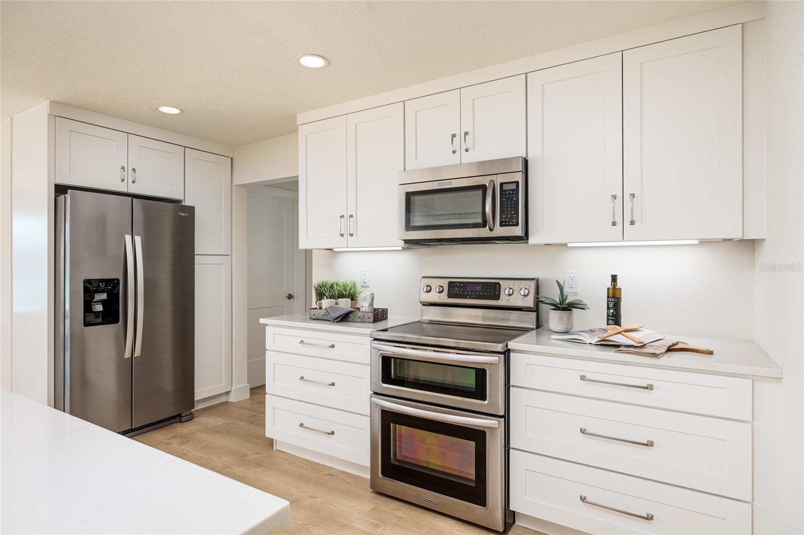 Modern stainless steel appliances complete this thoughtfully designed coastal kitchen