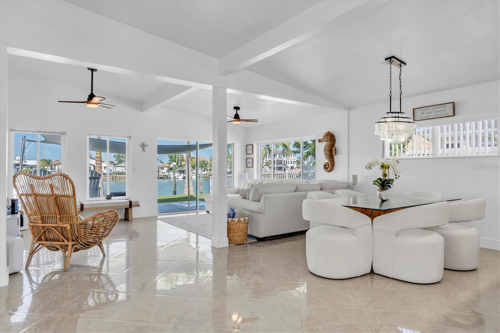 Enjoy stunning vistas of the Blind Pass channel, azure skies, and coastal landscaping. High ceilings and water views enhance the dining, living and kitchen areas, making every day of your life feel inspired.