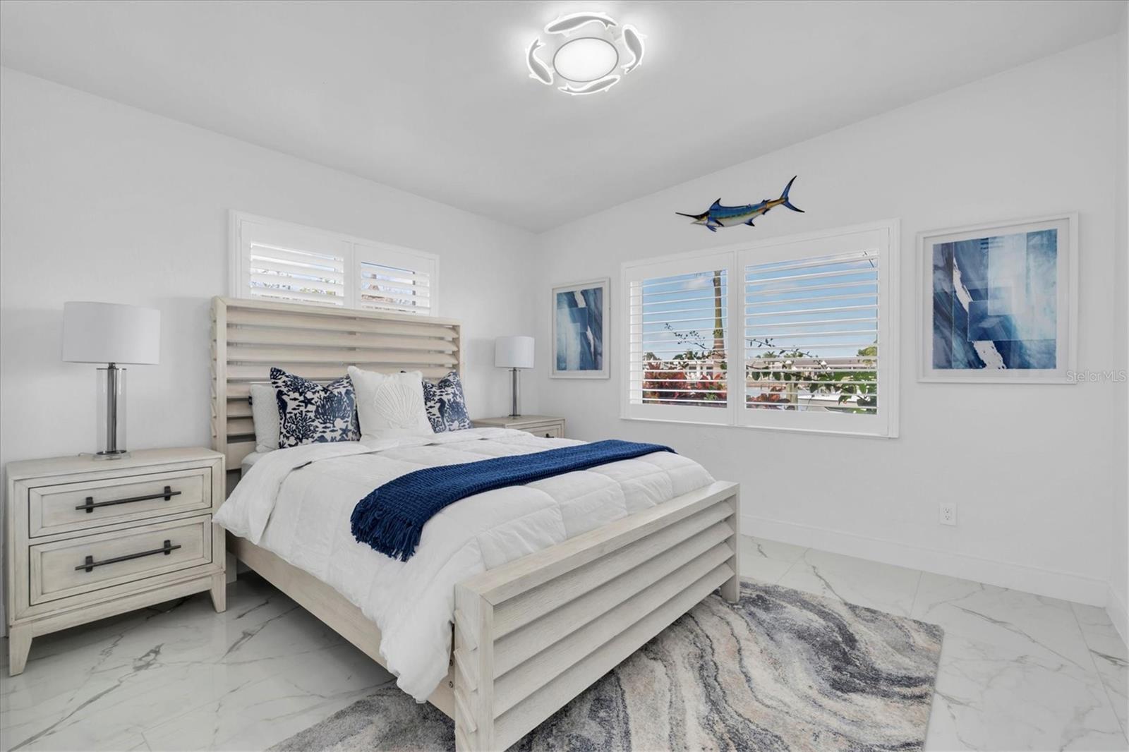 The third bedroom exudes a coastal vibe, offering stunning water views that bring the outdoors in!