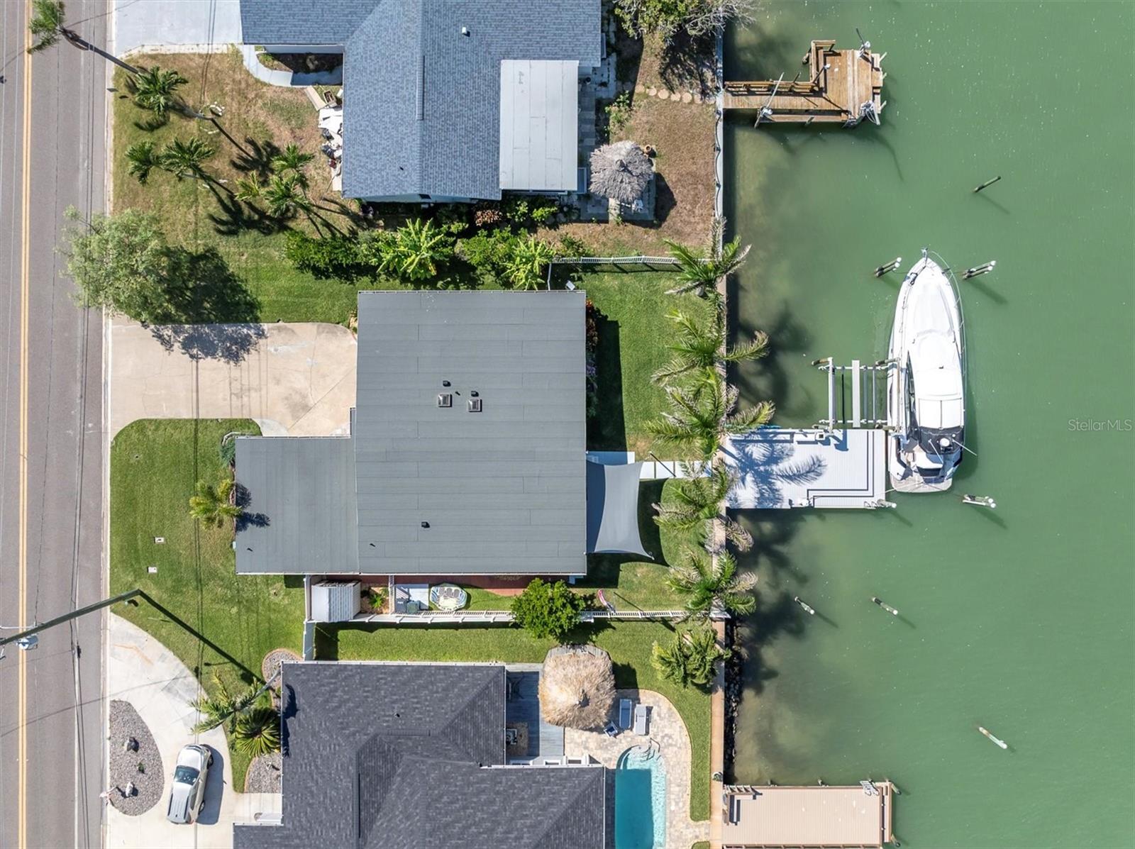 Refined curb appeal with concrete driveway, lush rear grounds, and deep-water access to the Gulf of America.