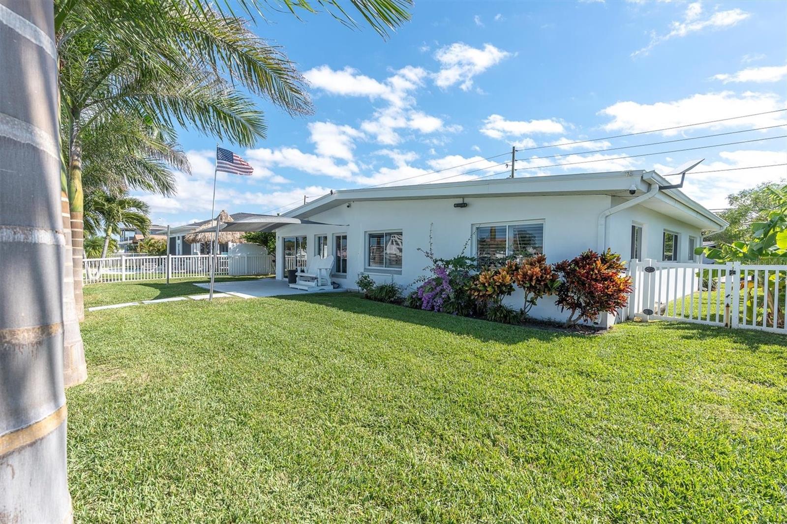 The yard offers lovely landscaping with plenty of room for outdoor entertaining Florida style!