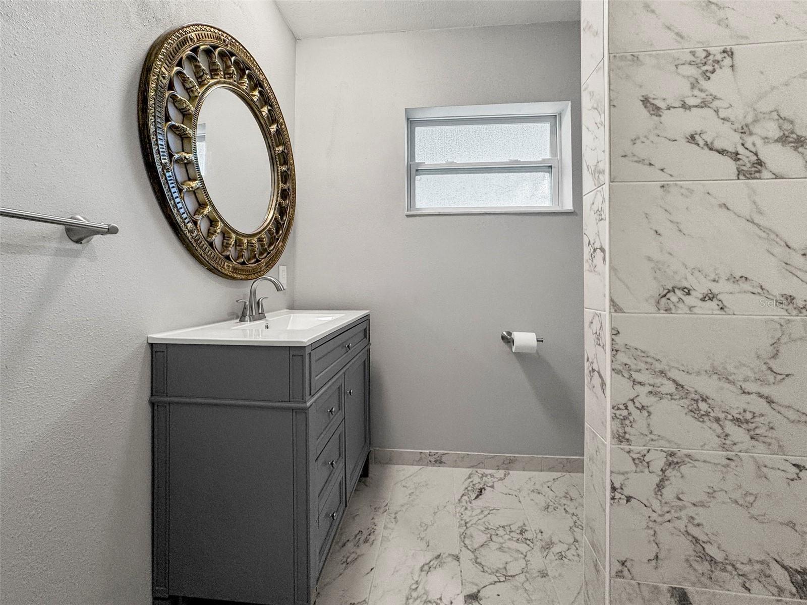 Updated Bathroom, New Vanity and Gleaming tile.