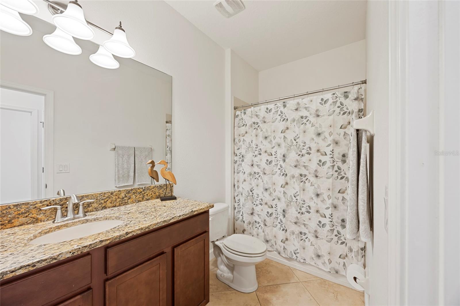 Bathroom 2 with granite countertops and combo shower/tub