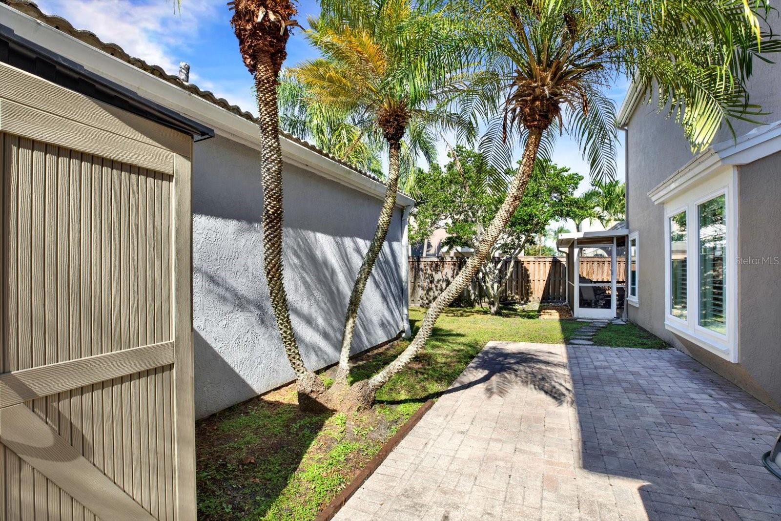 Patio w large paved area and a shed for yard tools