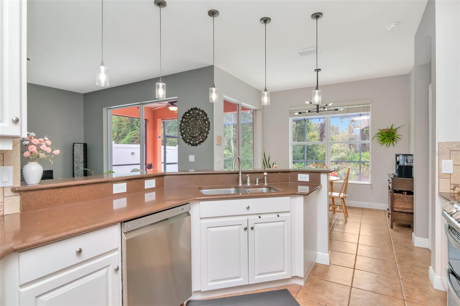 Kitchen  sink overlooks exterior pool area