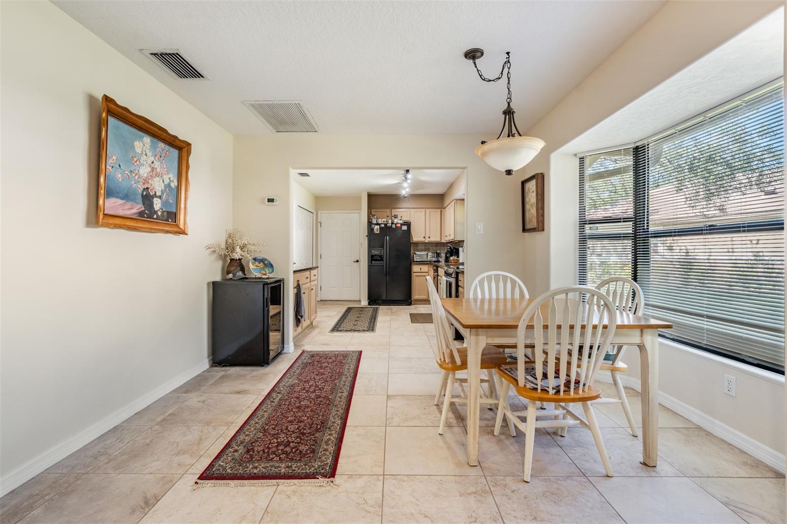 Kitchen table area (Or Dining Room)with tile flooring, lots of sunlight.
