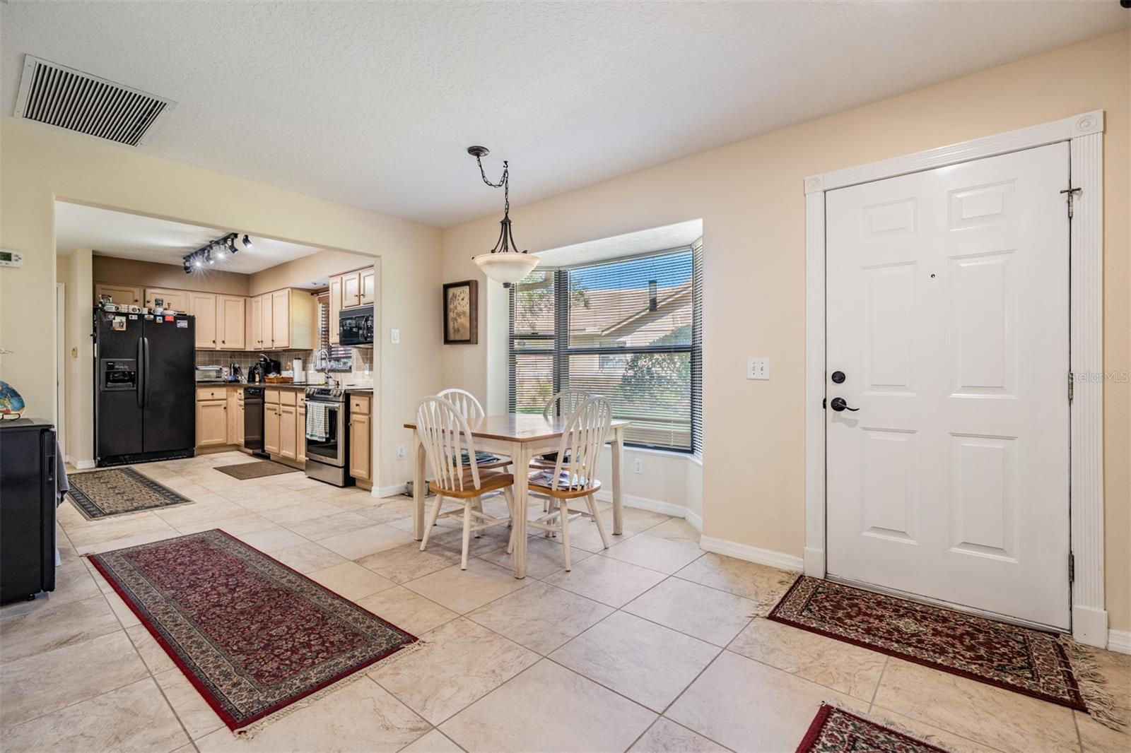 Kitchen table area (Or Dining Room)with tile flooring, lots of sunlight.