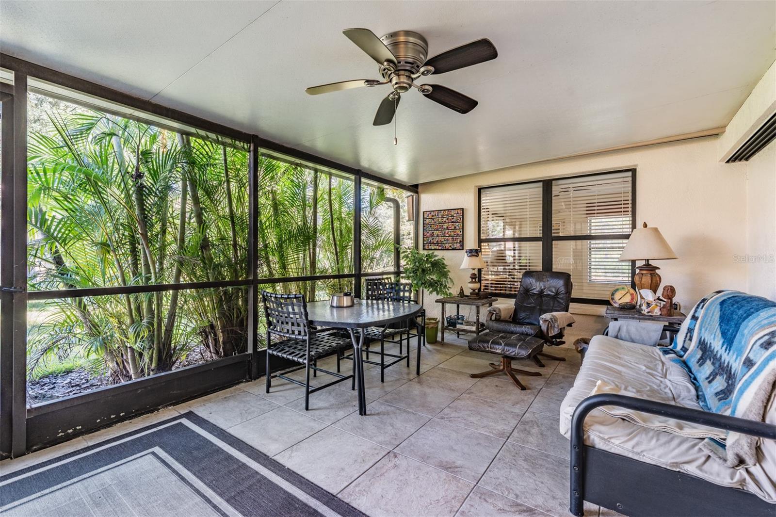 Front Porch, Tile flooring, Ceiling Fan, screened and covered.