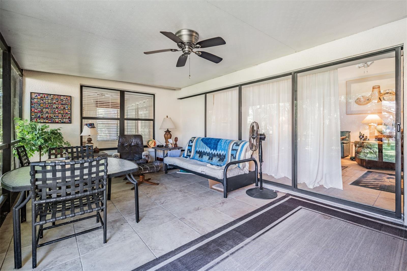 Front Porch, Tile flooring, Ceiling Fan, screened and covered.