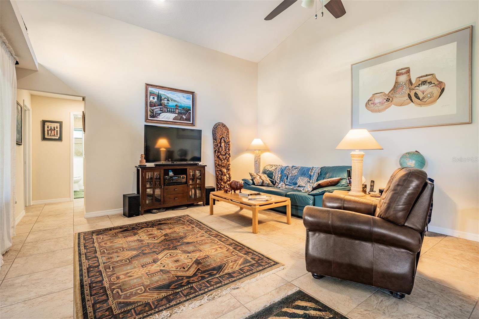 Family Room, Vaulted Ceilings, tile flooring, ceiling fan with light fixture