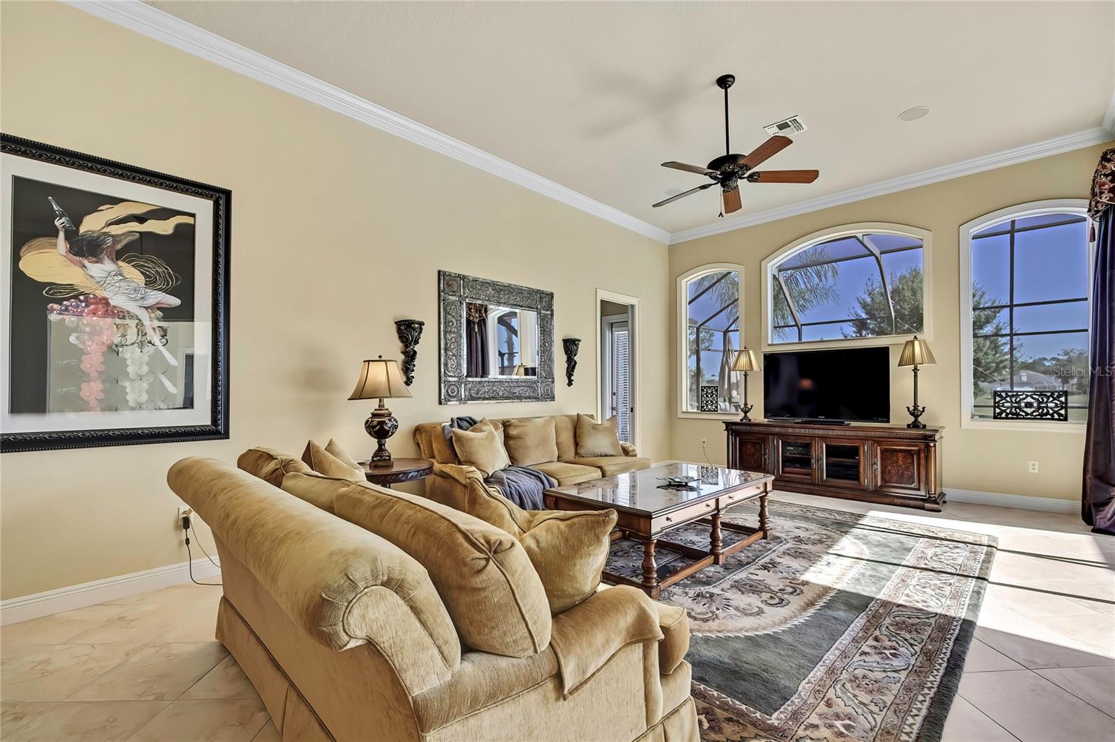 Spacious Family Room with crown molding and pocket sliders