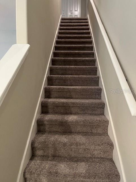 Stairs with updated carpet leading to all bedrooms upstairs.