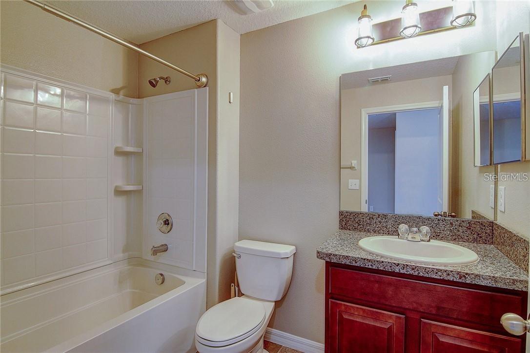 Upstairs Hall Bath with Tub and Updated Light Fixtures.
