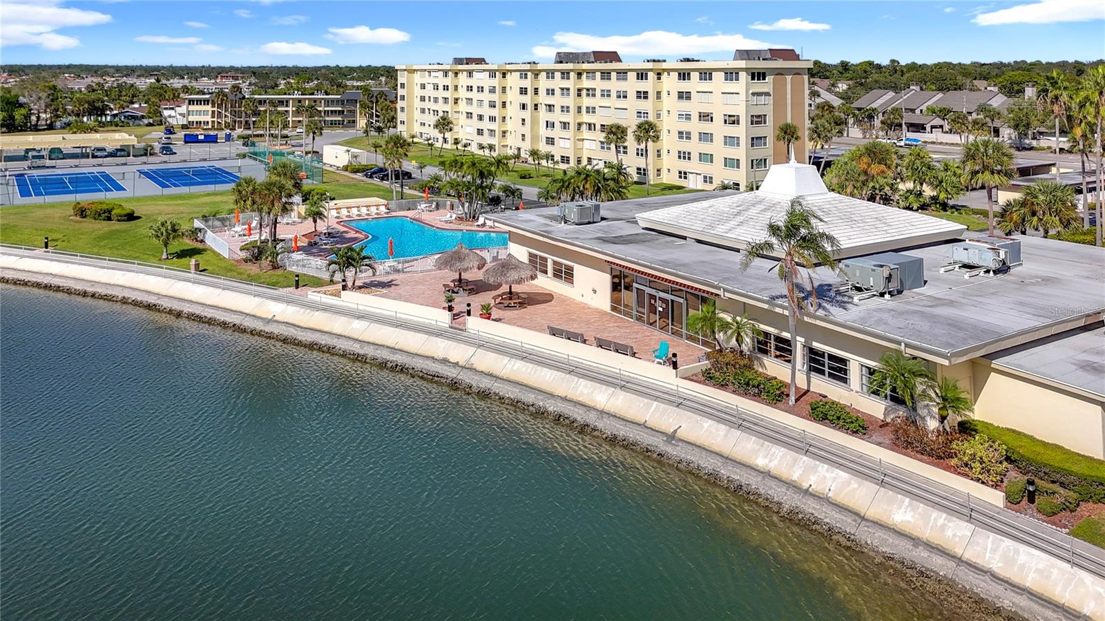 Nice aerial view of the clubhouse, tiki huts and pool area