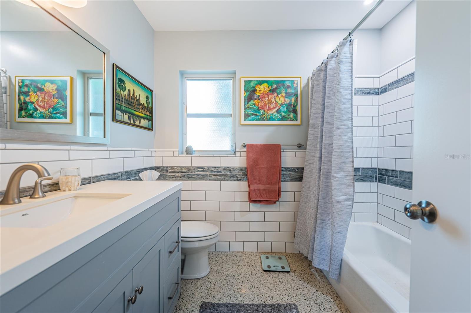 Beautifully updated hall bathroom with quartz counters.
