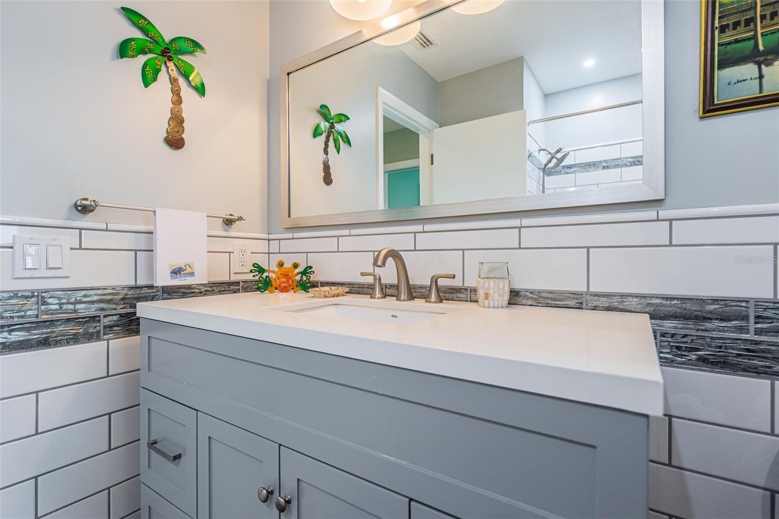 Beautifully updated hall bathroom with quartz counters.