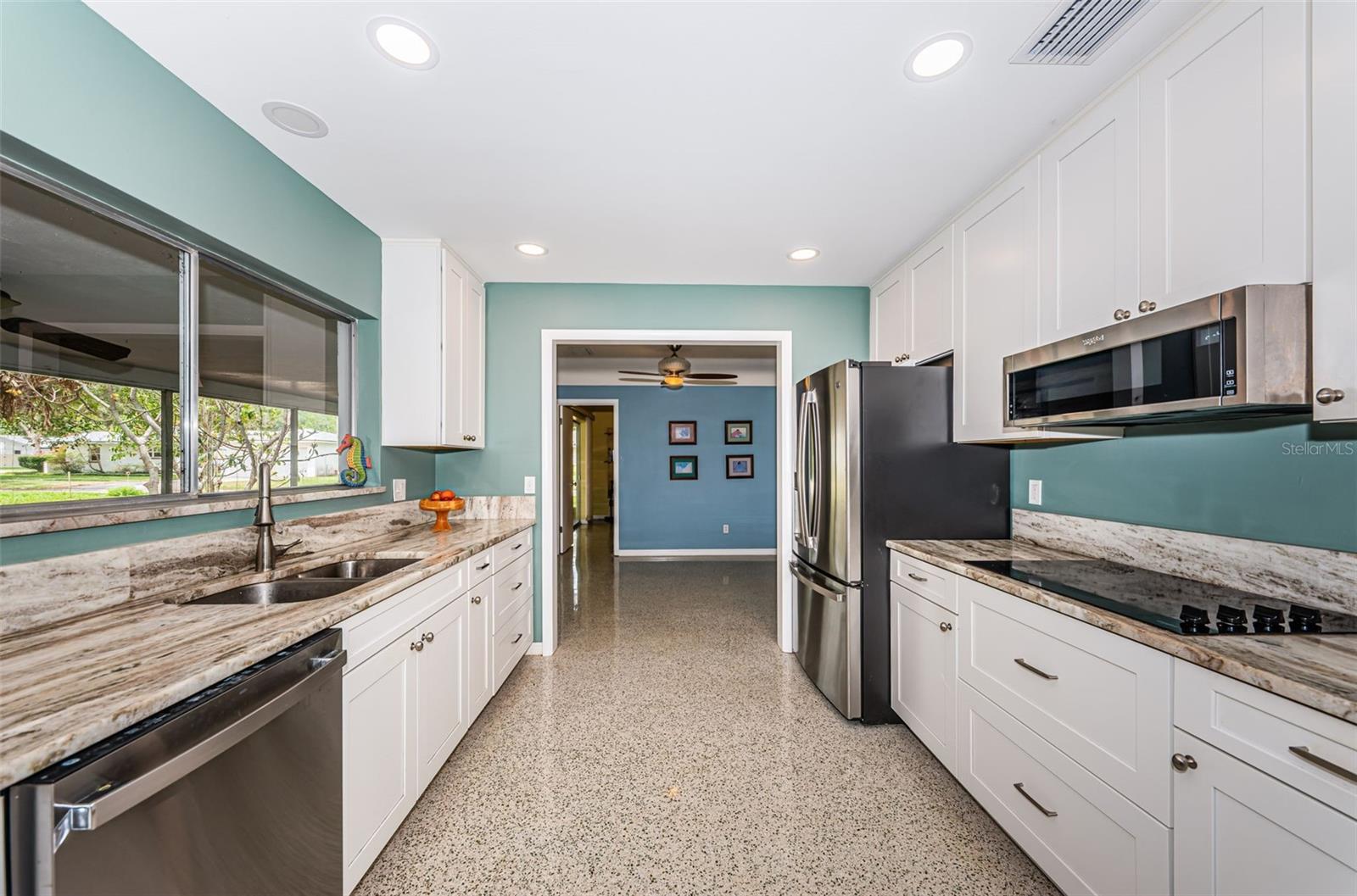 Updated kitchen with solid wood cabinetry, quartz counters, and stainless appliances.