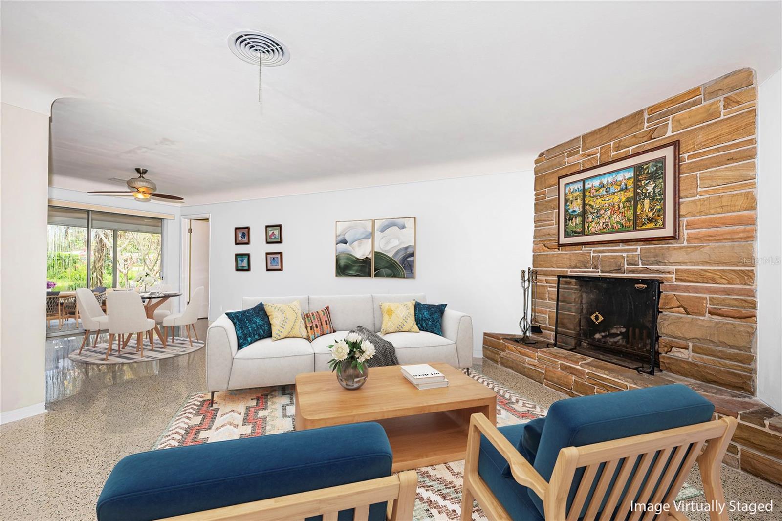Living room flanked by wood burning stone fireplace.