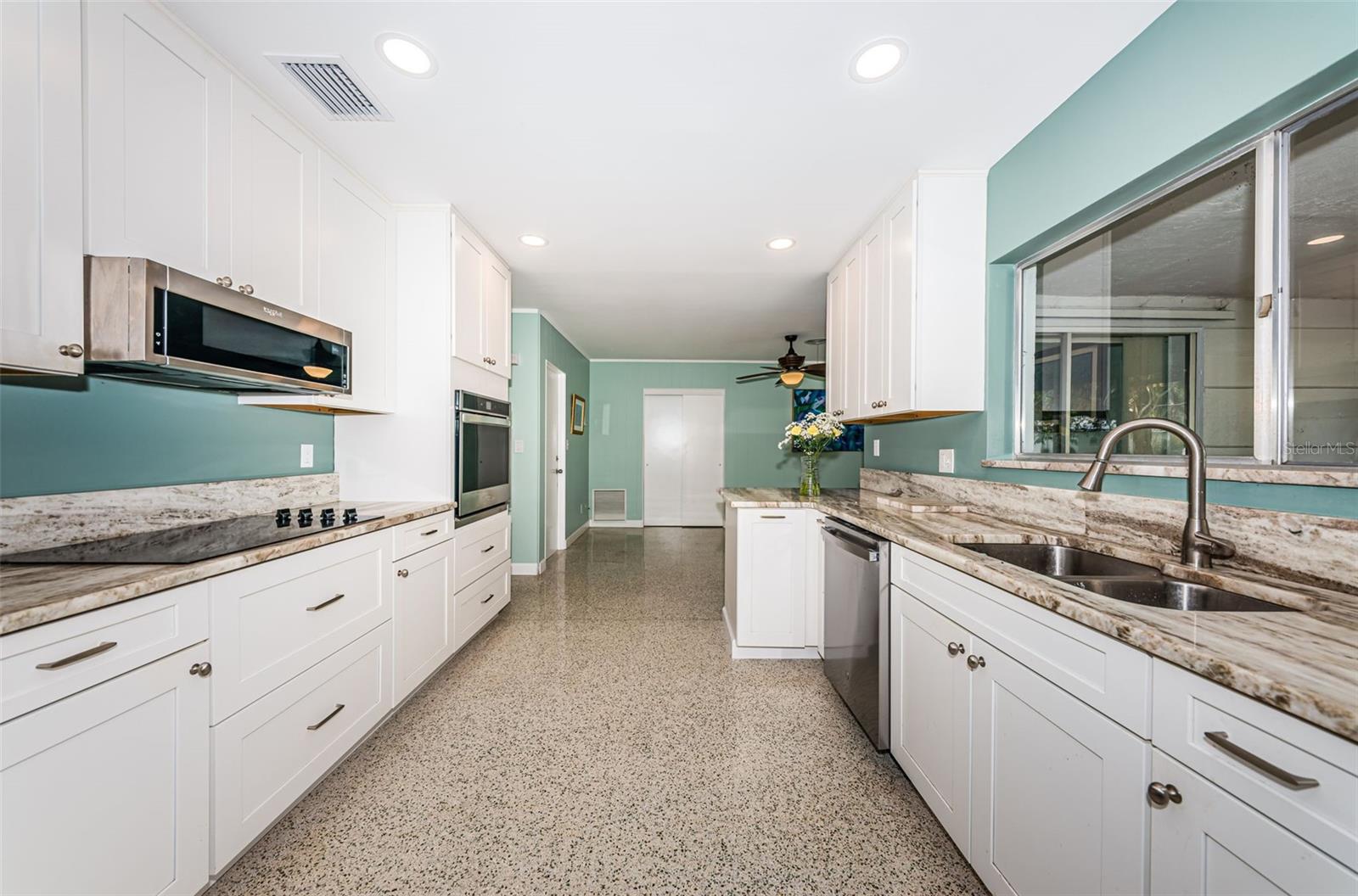 Updated kitchen with solid wood cabinetry, quartz counters, and stainless appliances.