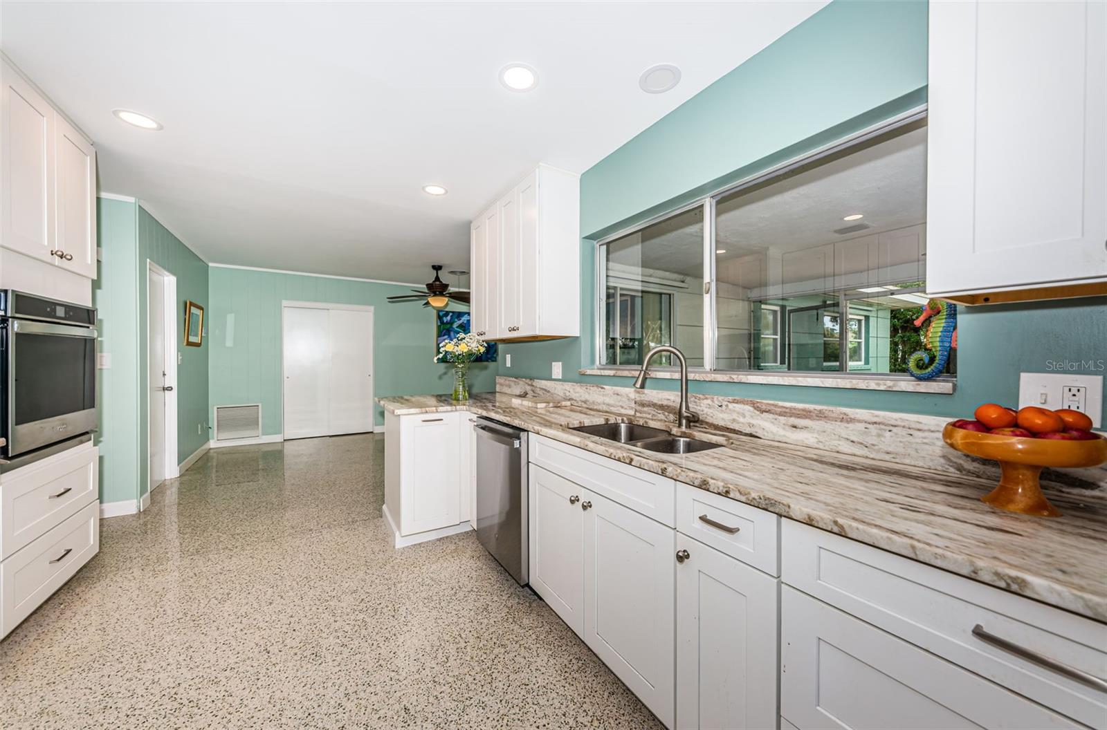 Updated kitchen with solid wood cabinetry, quartz counters, and stainless appliances.