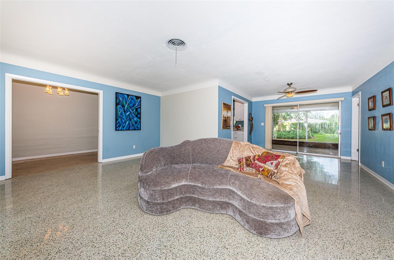 Living room flanked by wood burning stone fireplace.