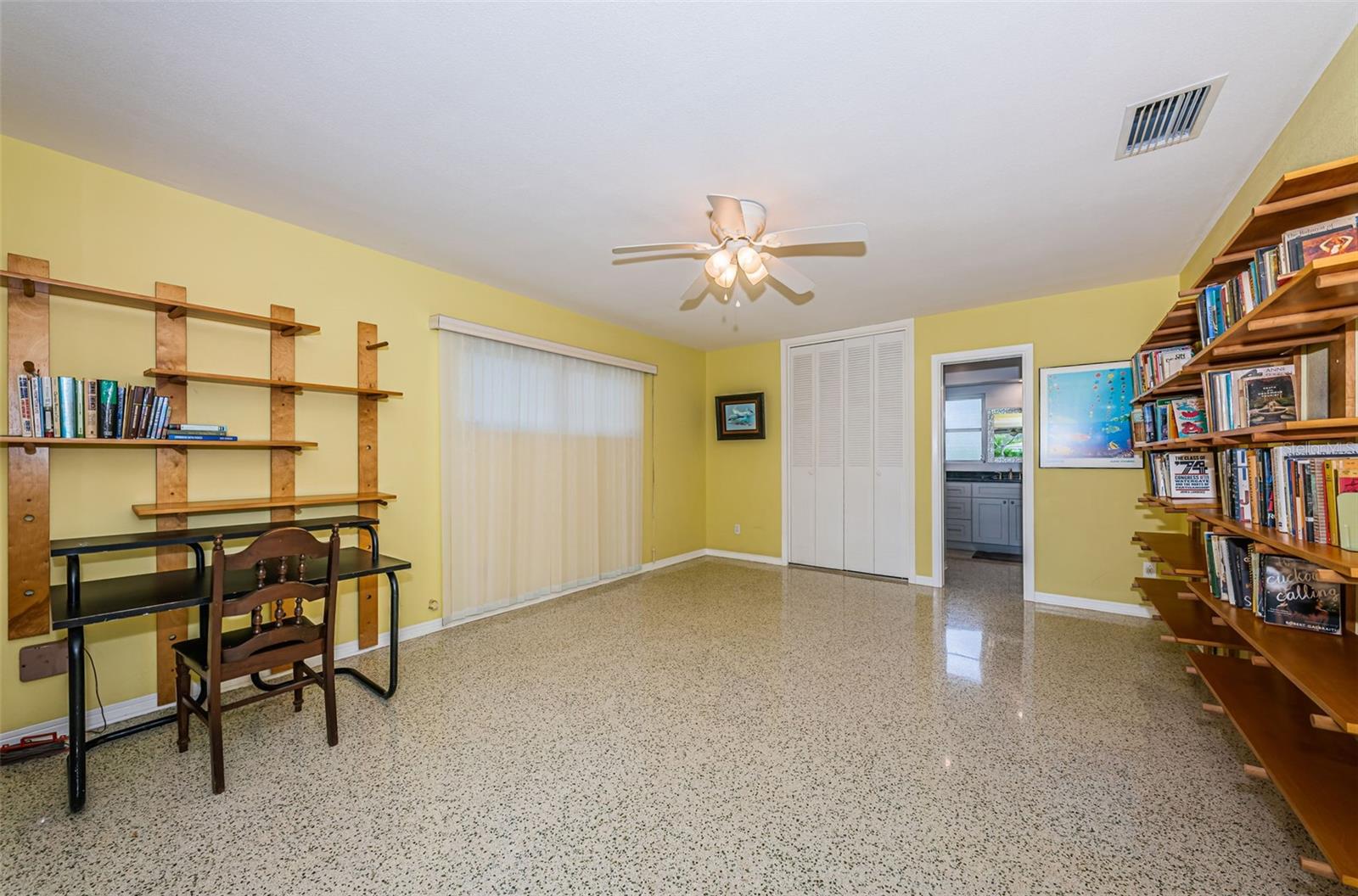 Primary bedroom with en-suite bathroom. It overlooks the large screened porch and backyard.